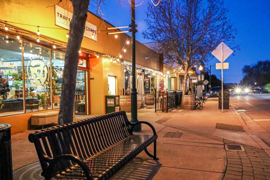 A bench on a sidewalk in front of a store located in Atascadero, Central Coast.