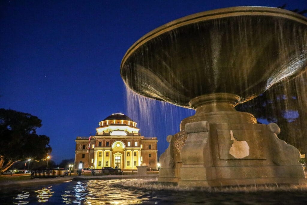 A central coast vacation rental in Atascadero with a fountain in front of a building at night.