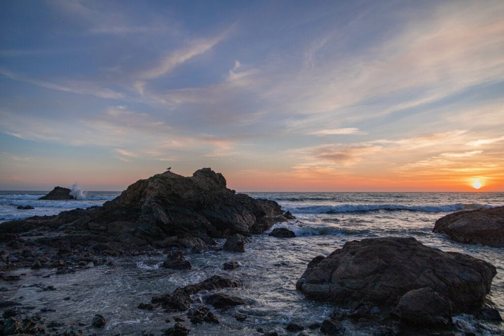 A rocky beach at Morro Bay at sunset.