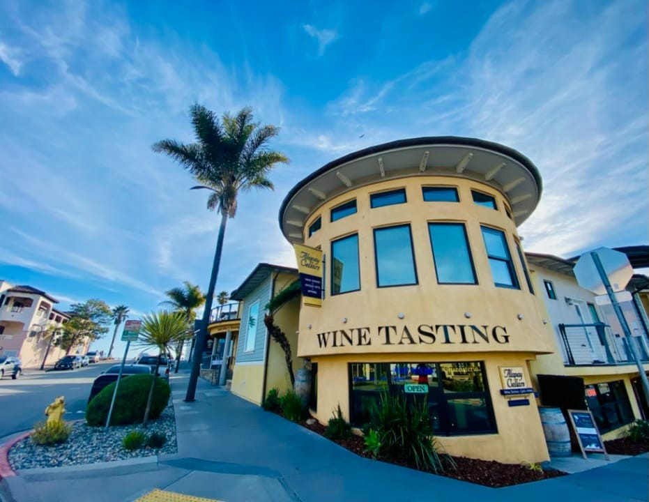 A yellow building in Morro Bay with a sign that says wine tasting.