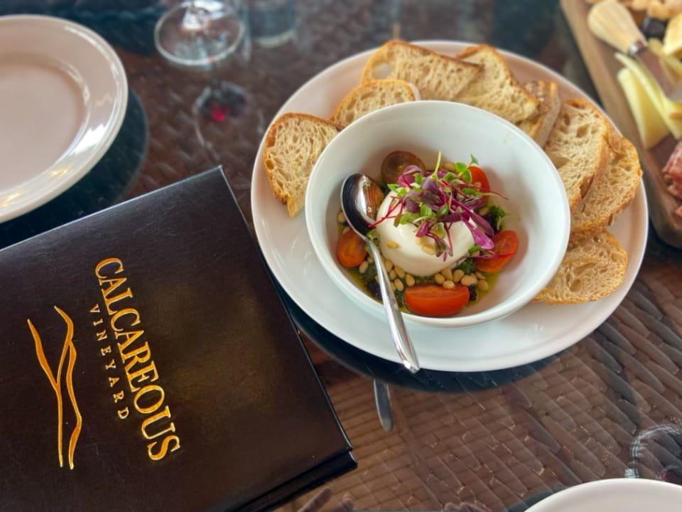 A bowl of soup and bread on a table at a vacation rental in Paso Robles.