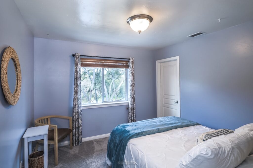 A vacation rental in Morro Bay on the central coast with blue walls and a white bed.