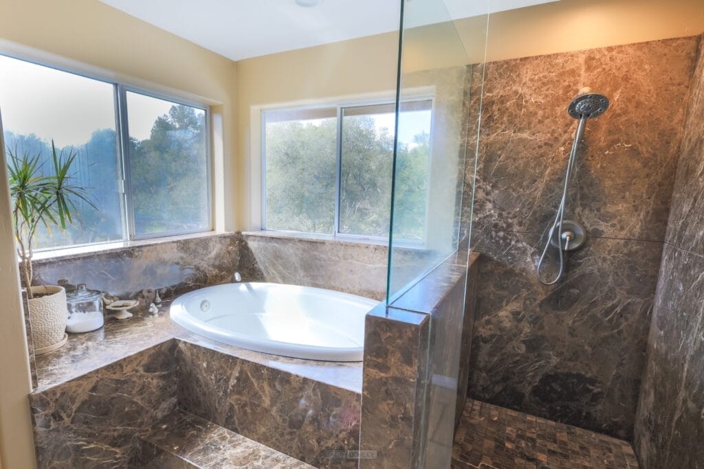 A bathroom with a tub, shower, and central coast ambiance.