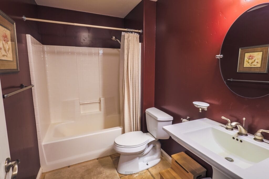 A vacation rental with red walls and a toilet.