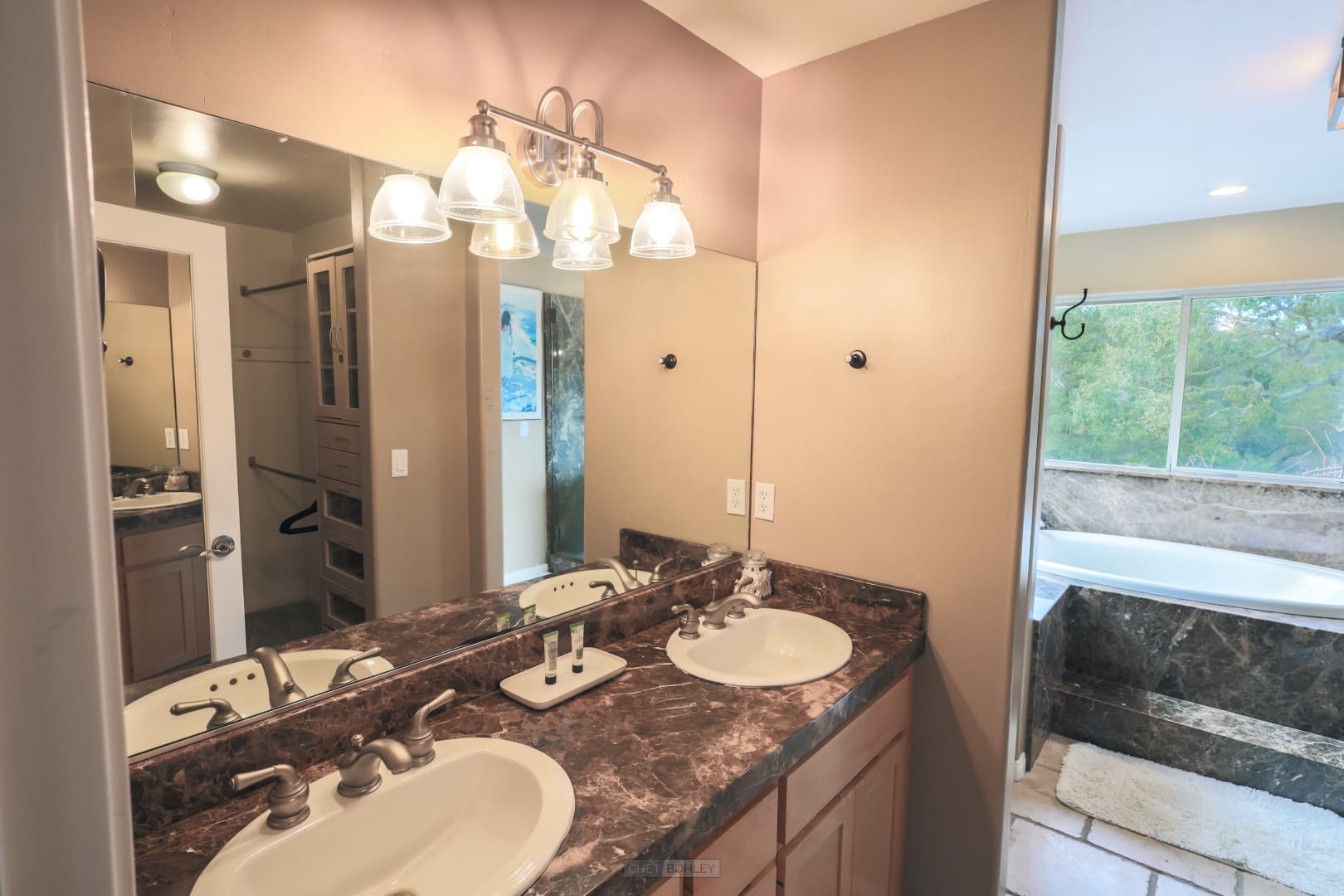 A vacation rental in Morro Bay featuring a bathroom with two sinks and a bathtub.