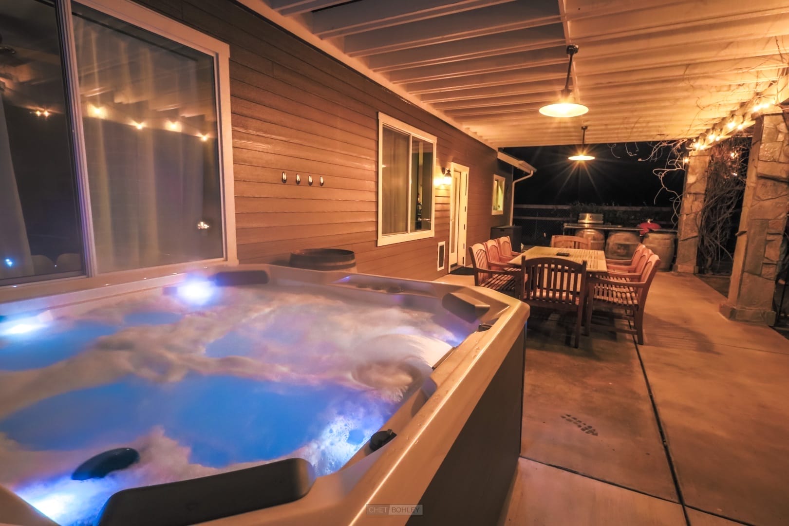 A centrally-located hot tub on a deck at night, perfect for your Atascadero vacation rental.