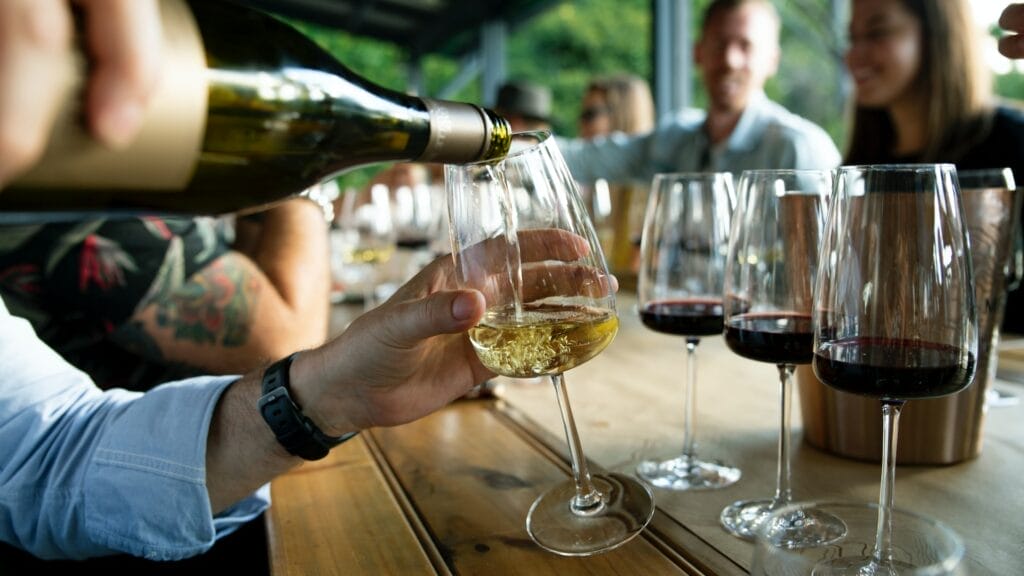 A group of people pouring wine at a table in Central Coast.