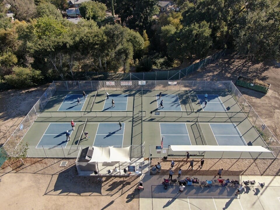 An aerial view of a tennis court with people playing in Paso Robles.
